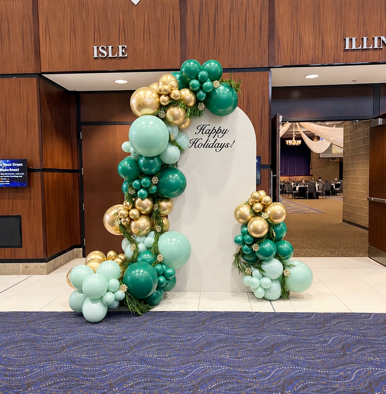 Green and gold holiday balloon installation